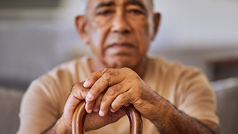 A elderly man with a cane