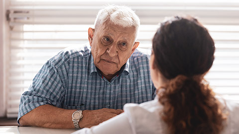 An elderly client talking to a client