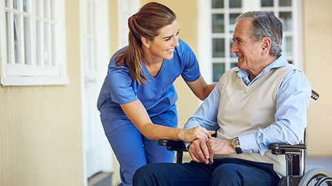 healthcare social worker talking to a senior person with disability