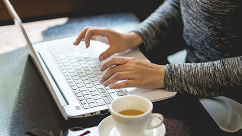 woman working and typing on a laptop