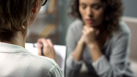 Young depressed woman talking to lady psychologist during session, mental health