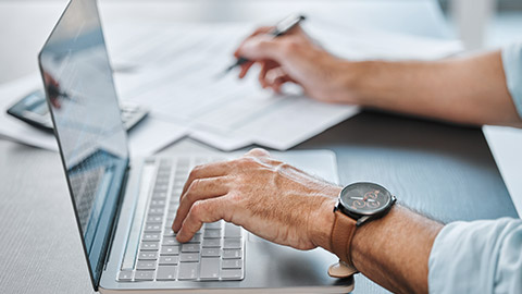 A person typing on a laptop