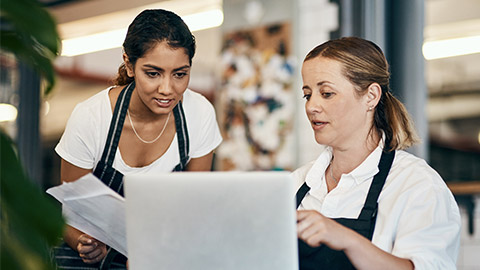 Restaurant, waitress or manager on laptop