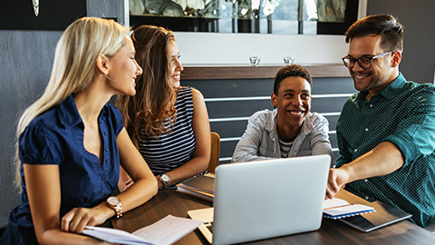 Shot of colleagues working on a project using a laptop