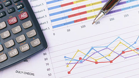 summary report and calculator on table office.