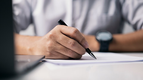 In the office, a businessman signs a document paper