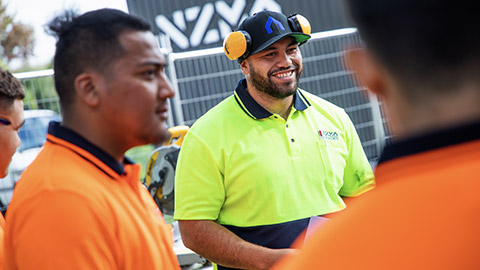 A site manager talking to workers