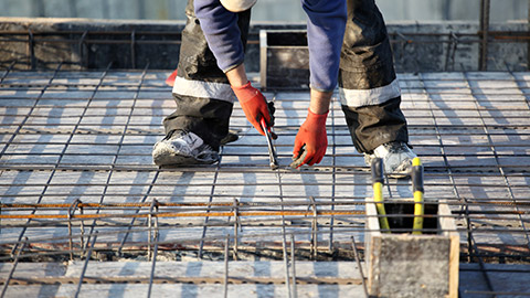 A person working on reinforcing material