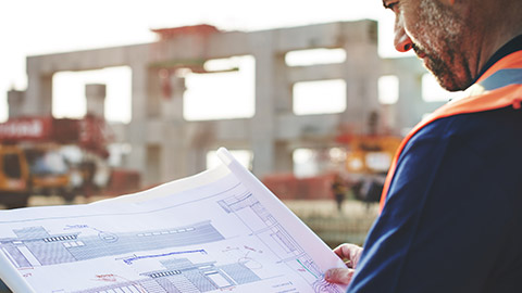 A foreman looking at plans on site