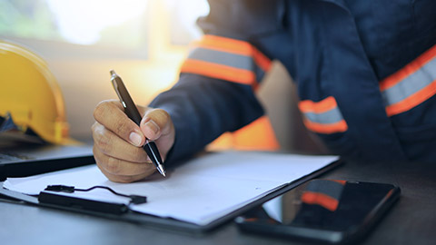 A close view of a contractor looking at paperwork