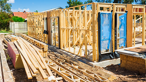 A building under construction with materials stacked nearby