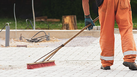 A person sweeping on a construction site