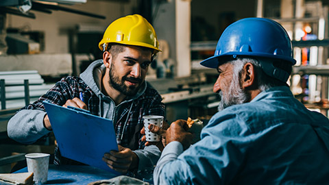 2 construction workers talking on a site