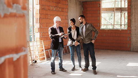 Buiilder with clients on a construction site