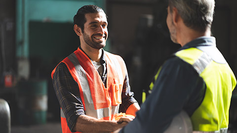 A construction worker and colleague talking