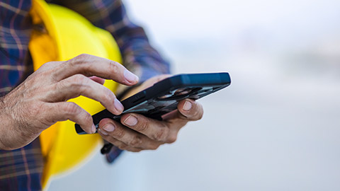 A person using a phone on a construction site