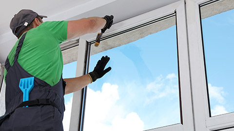 A person installing double-glazed windows