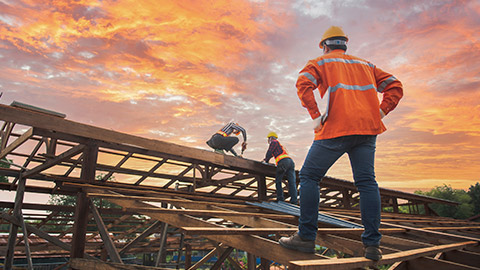 A worker standing on a roof