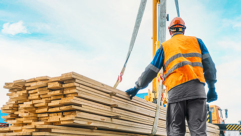 A worker lifting building materials