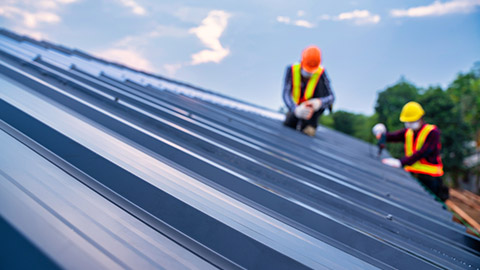 Workers putting on a roof