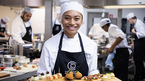 A chef with a tray of food