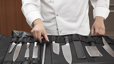 A chef with a bunch of knives