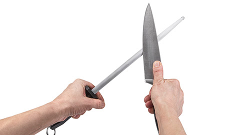 A person sharpening a knife