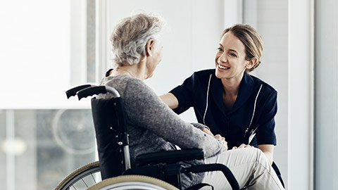 A carer talking to a client with a smile on their face