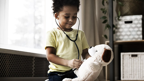 A toddler playing doctor