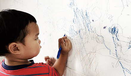 A child drawing on a wall