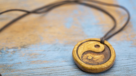 A close view of a yin yang necklace