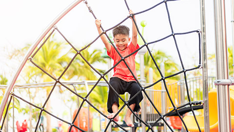 A child playing on outdoor equipment