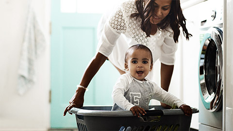 A mom and her son doing the laundry