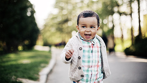 A child happily walking on a path