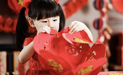 A chinese girl making traditional chinese paper baskets