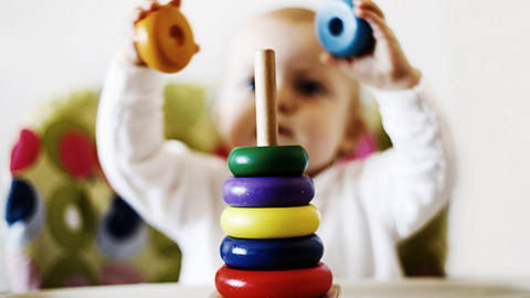 A child playing with developmental toys