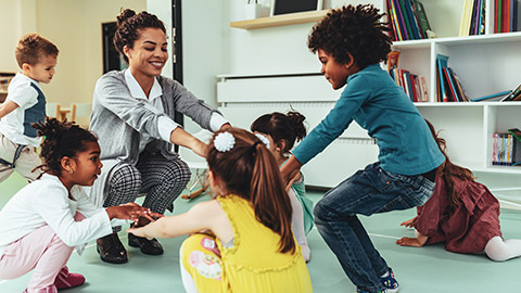 A childcare worker interacting with kids