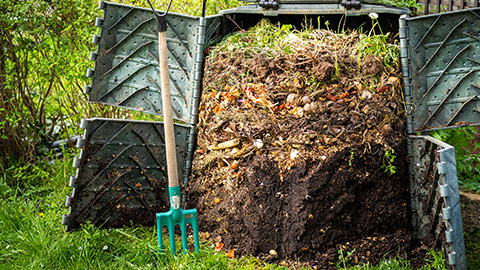 A compost bin opened up showing layers of decomposition