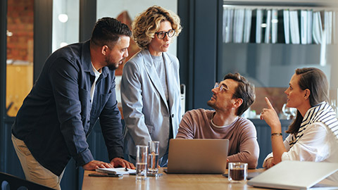 A group of people talking in an office