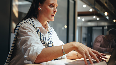 A manager talking to someone on a laptop