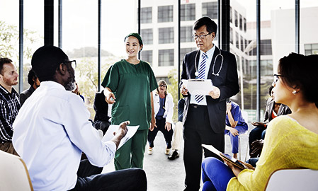 A doctor teaching aspiring carers