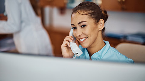 A medical professional talking on a phone