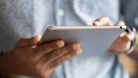 Close up hands African man holding digital tablet device