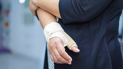 A person wearing a wrist brace