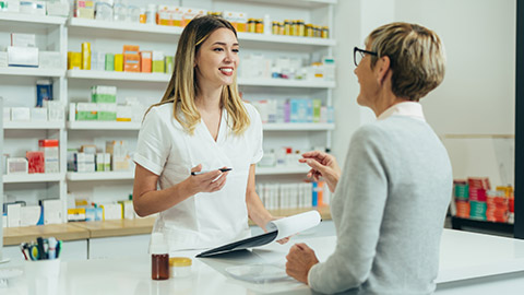 A pharmacist talking to an elderly client