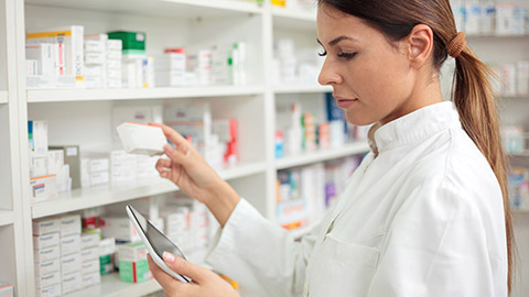 A pharmacist locating medicine on shelves