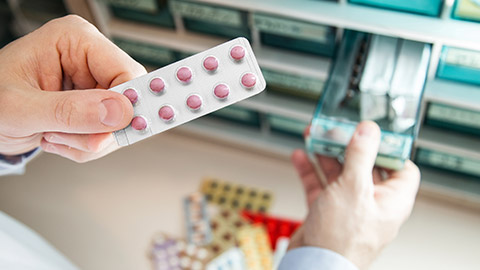 A pharmacist holding medication