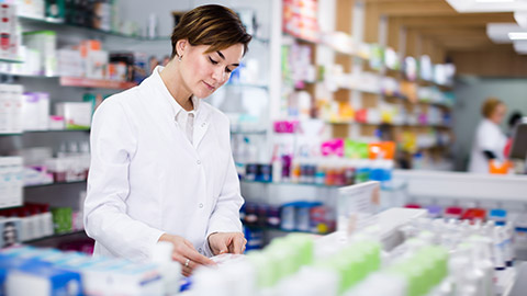 A pharmacist reading a prescription