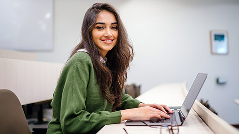 A person using a laptop at a desk