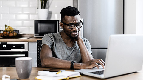 A person looking seriously at a laptop